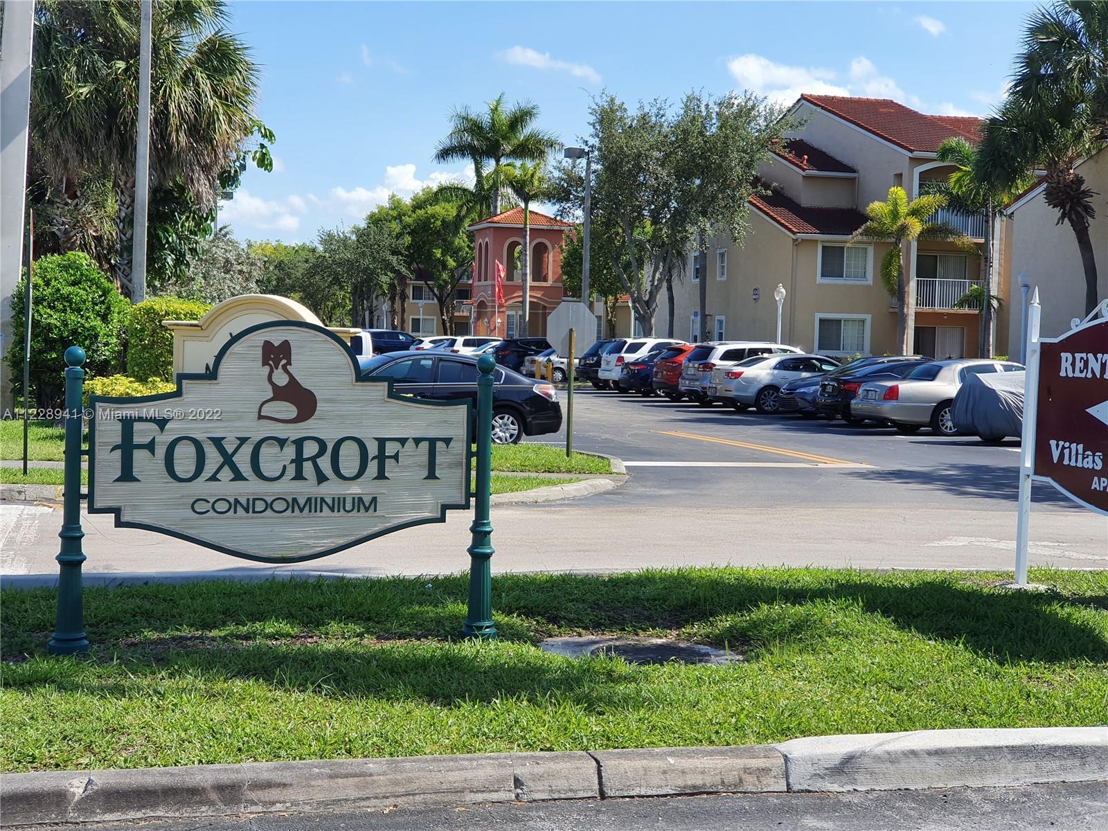 3490 Foxcroft Road, Unit B305 Miramar, FL 33025 - Photo 1 of 30 a view of street and sign board with large trees