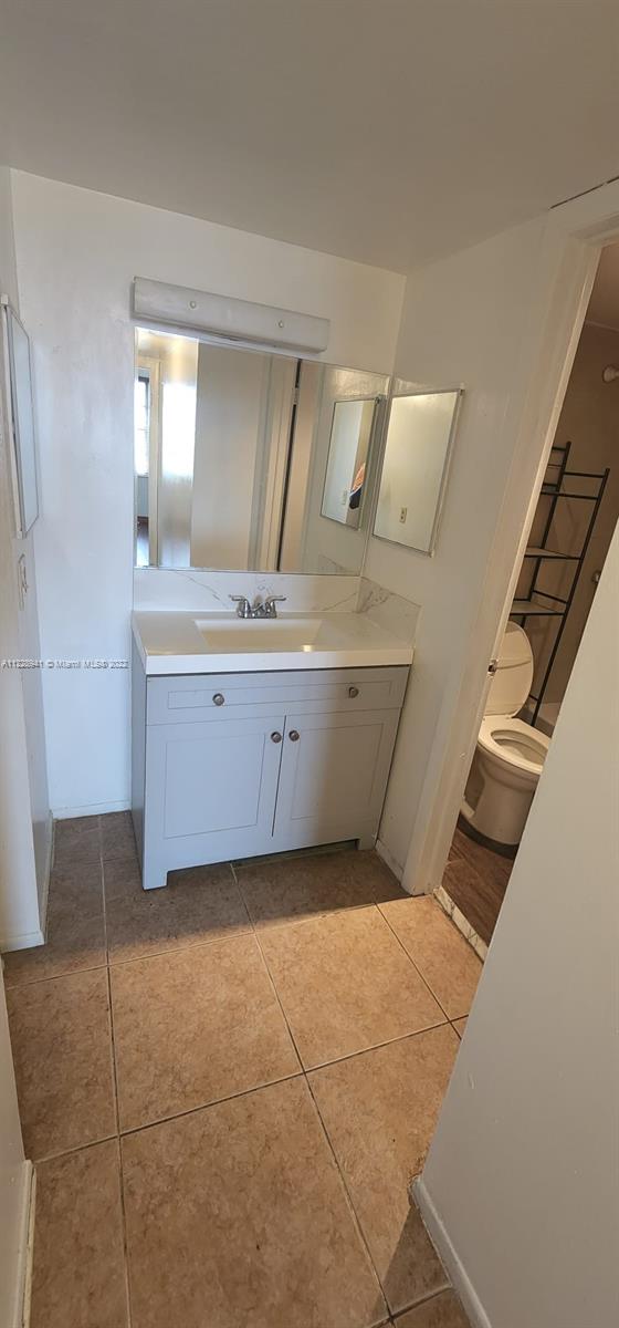 3490 Foxcroft Road, Unit B305 Miramar, FL 33025 - Photo 16 of 30 a bathroom with a granite countertop sink and mirror