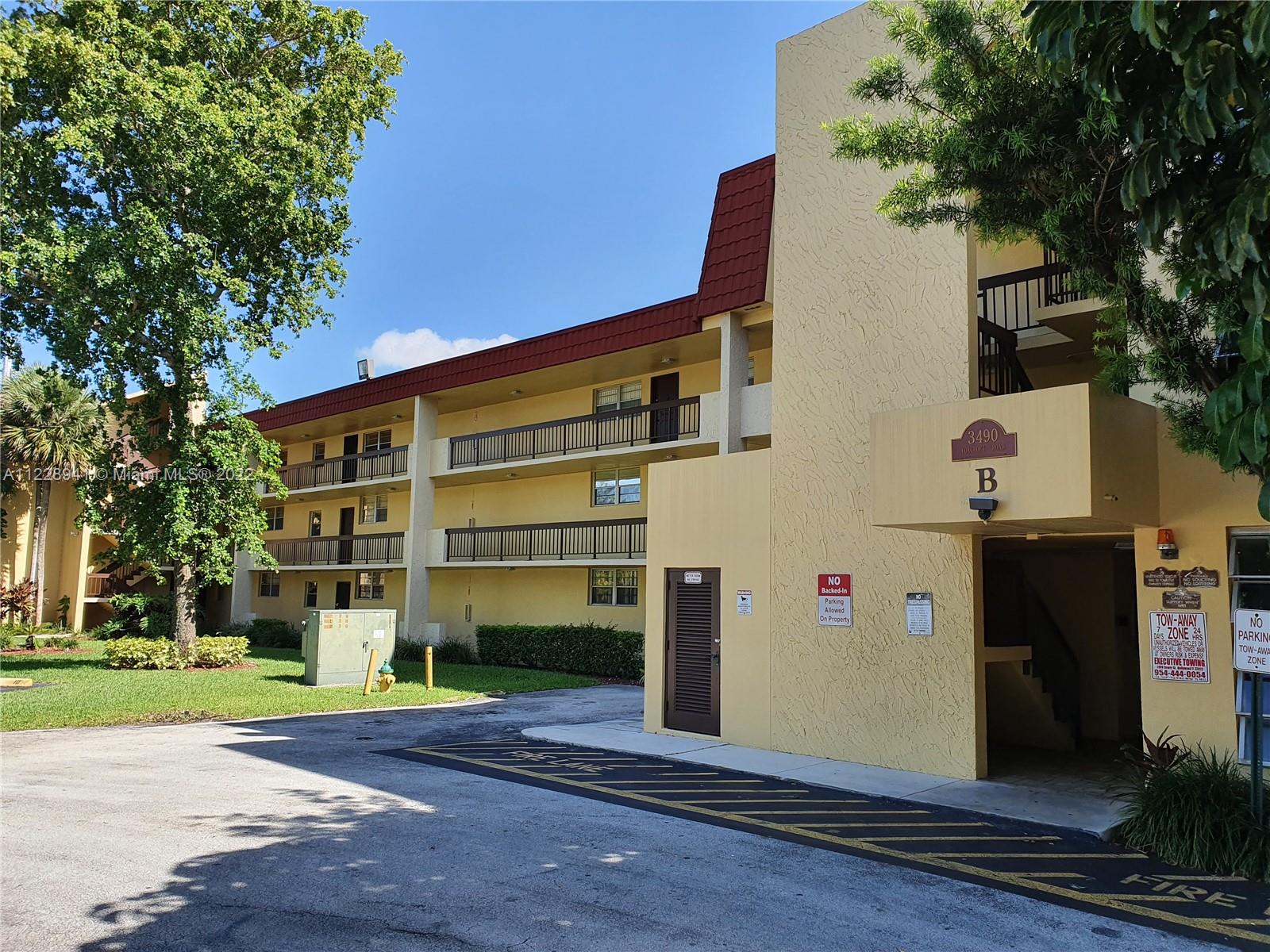 3490 Foxcroft Road, Unit B305 Miramar, FL 33025 - Photo 2 of 30 a front view of a building with a garden