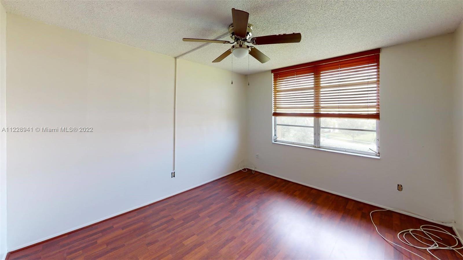 3490 Foxcroft Road, Unit B305 Miramar, FL 33025 - Photo 23 of 30 a view of empty room with wooden floor and fan