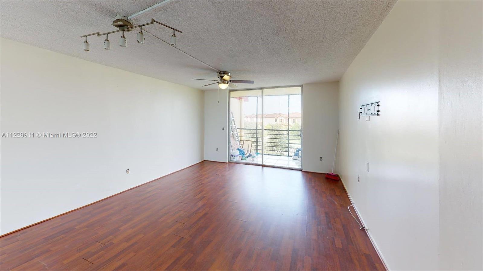 3490 Foxcroft Road, Unit B305 Miramar, FL 33025 - Photo 24 of 30 wooden floor in an empty room with a window