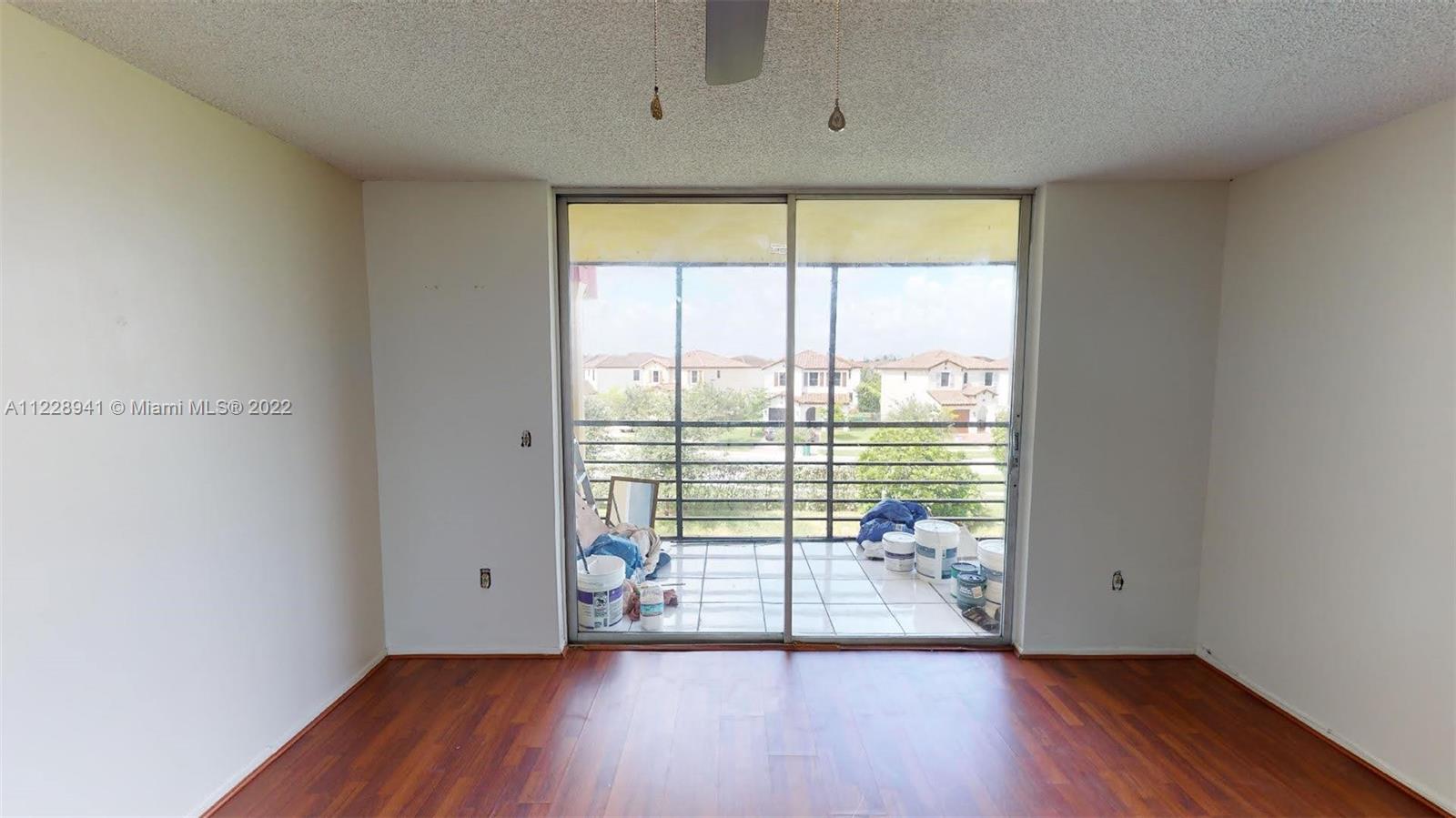 3490 Foxcroft Road, Unit B305 Miramar, FL 33025 - Photo 8 of 30 wooden floor in an empty room with a window
