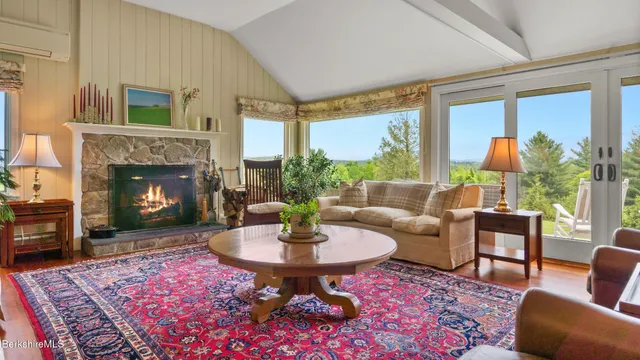 a living room with furniture a fireplace and a table