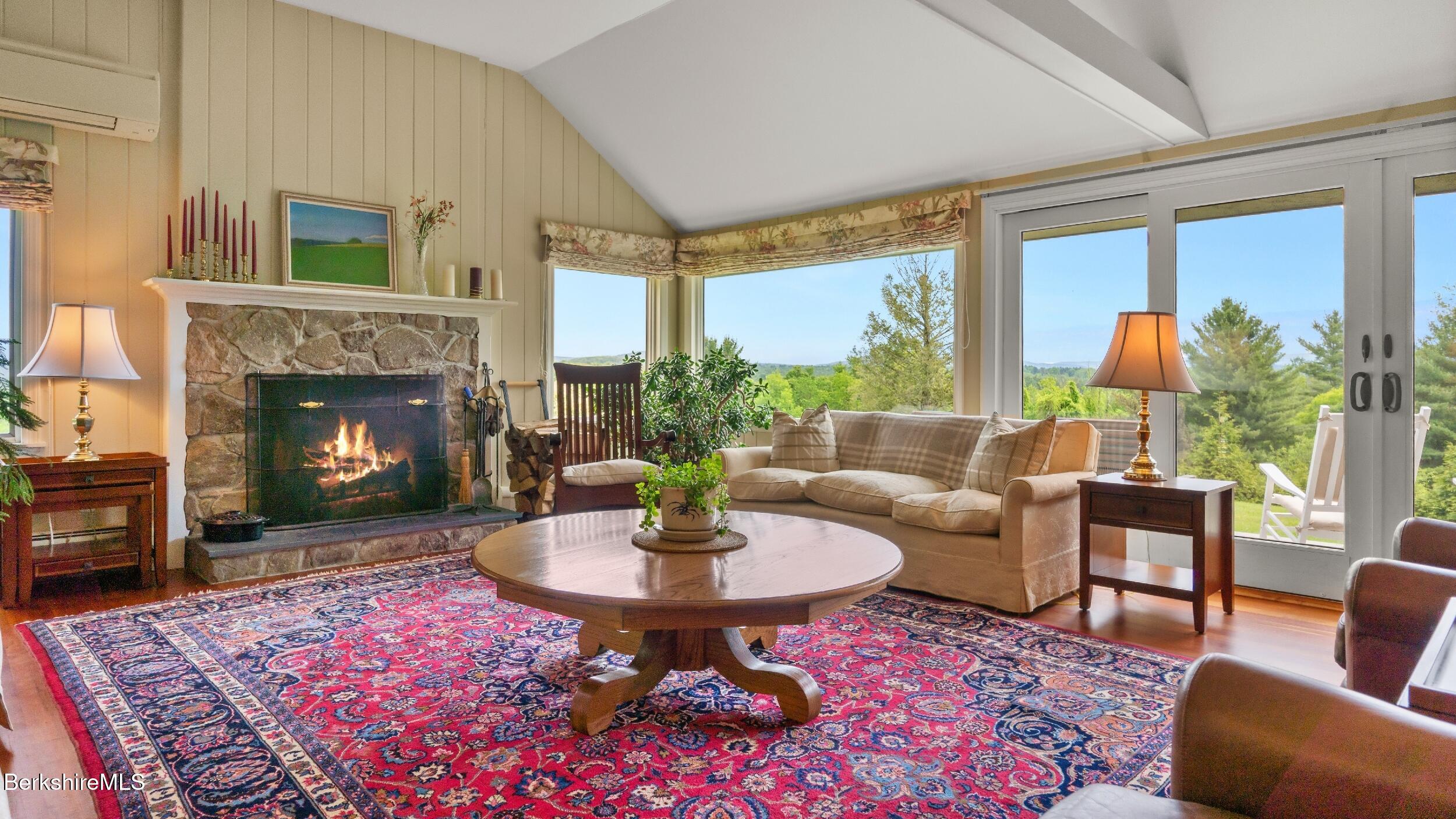 24 Baldwin Hill Road East Egremont, MA 01230 - Photo 12 of 47 a living room with furniture a fireplace and a table