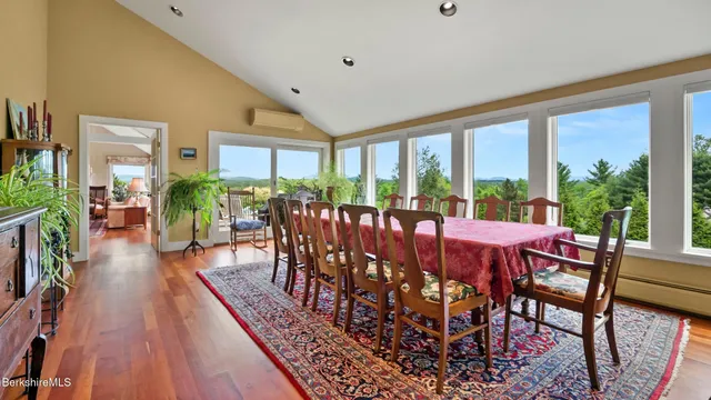 a view of a dining room with furniture window and wooden floor