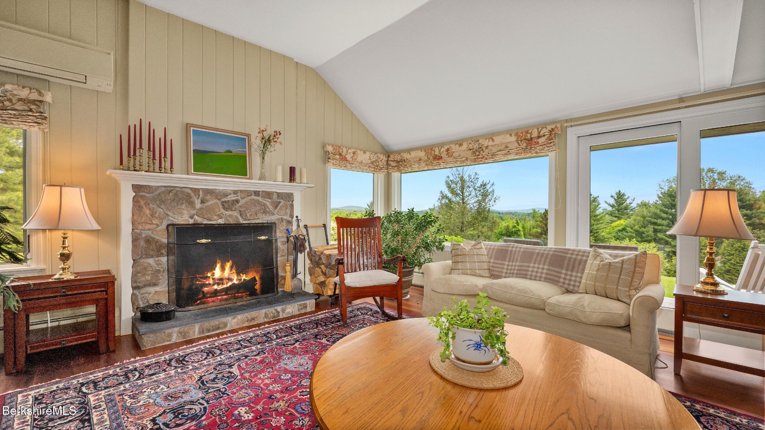 24 Baldwin Hill Road East Egremont, MA 01230 - Photo 19 of 47 a living room with furniture a fireplace and a large window