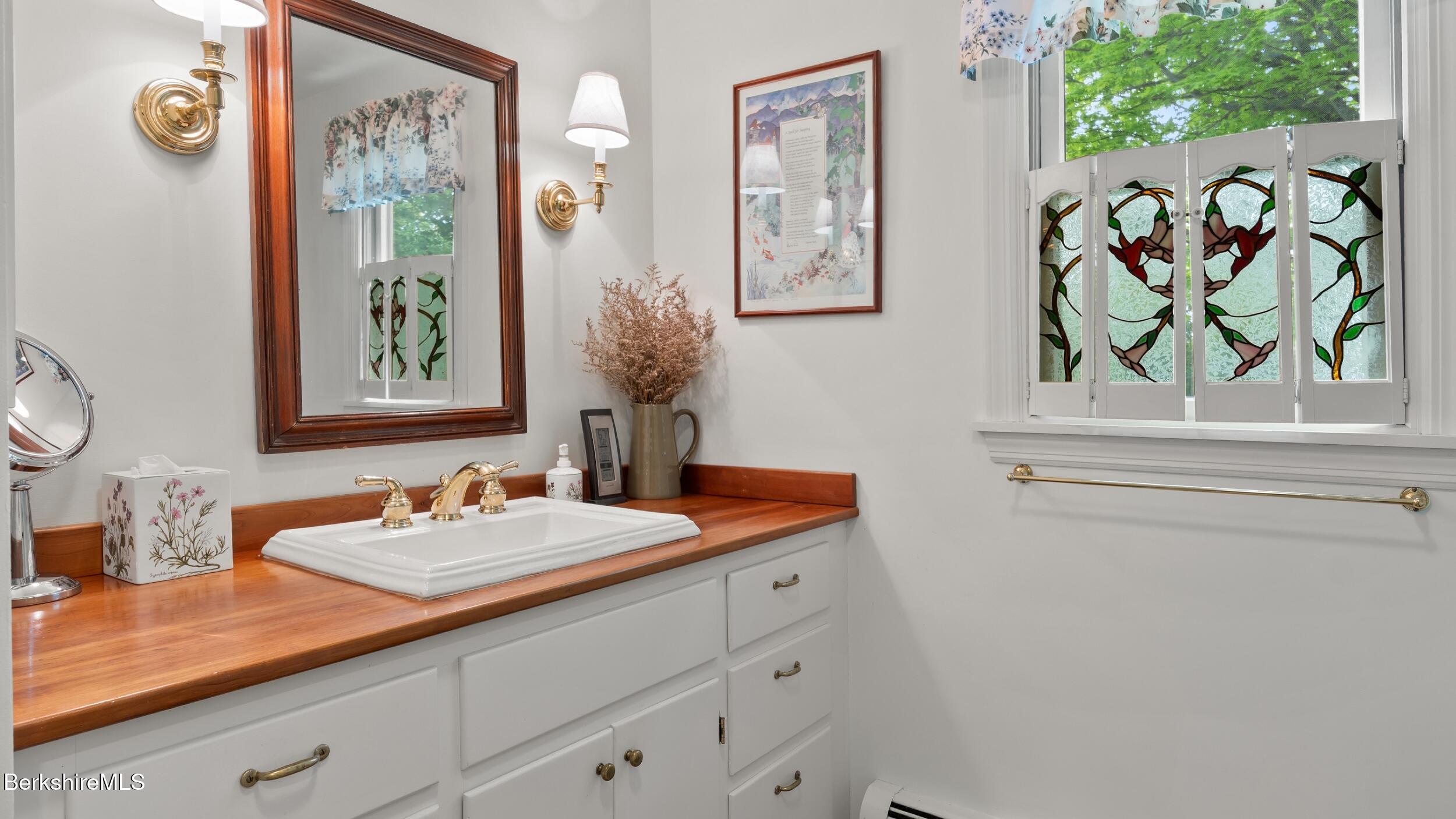 24 Baldwin Hill Road East Egremont, MA 01230 - Photo 24 of 47 a bathroom with a sink a mirror and a window