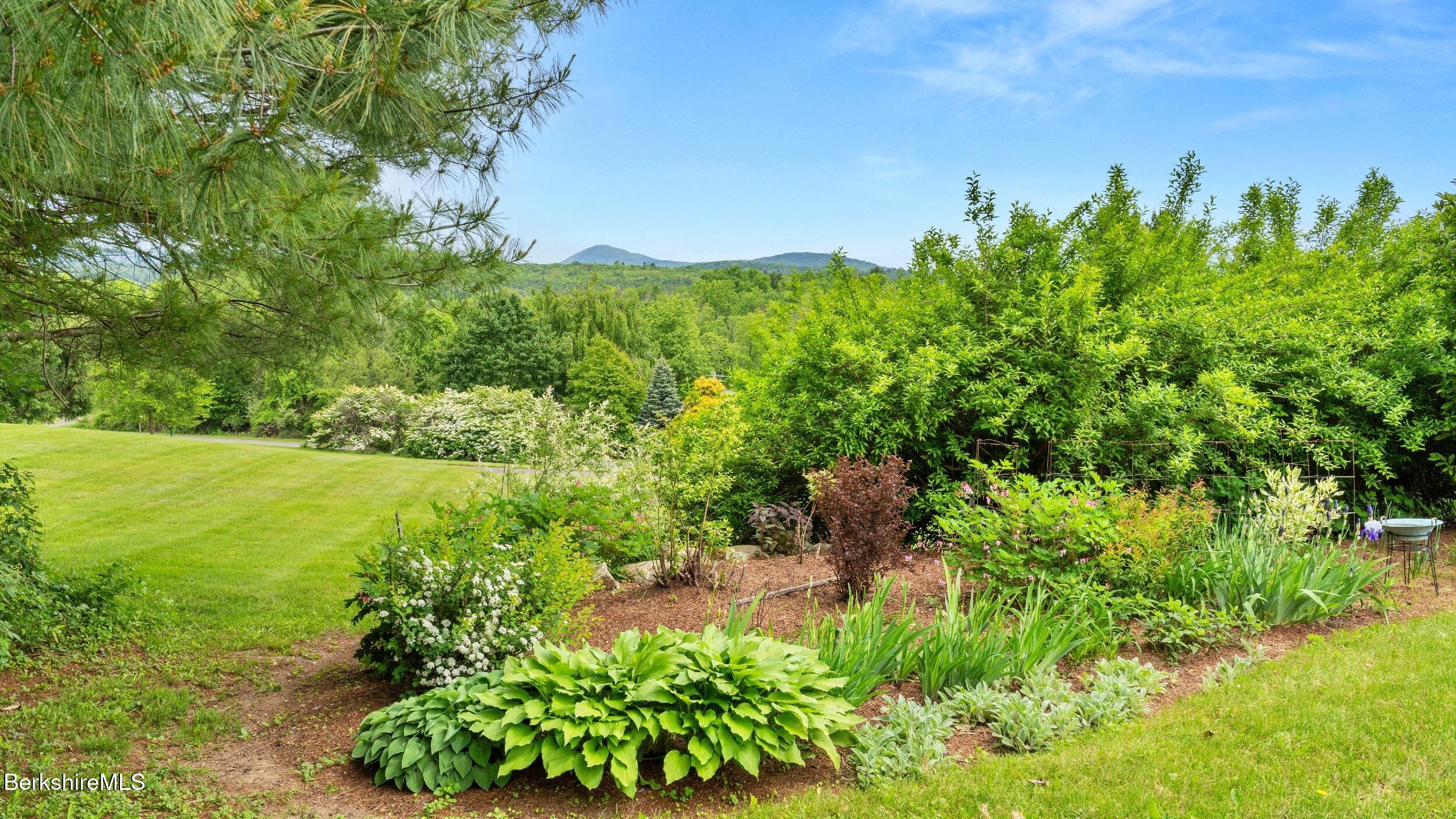 24 Baldwin Hill Road East Egremont, MA 01230 - Photo 38 of 47 a view of a garden with a building in front of it
