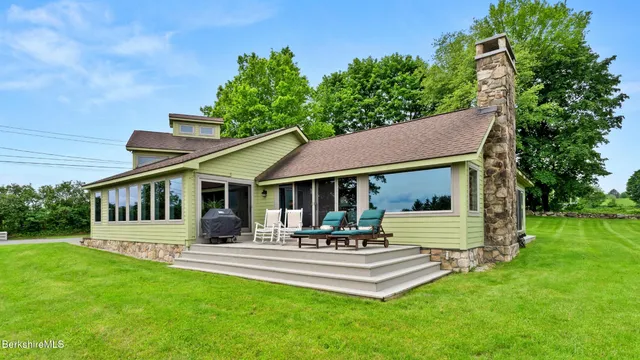 a view of a house with a backyard porch and sitting area
