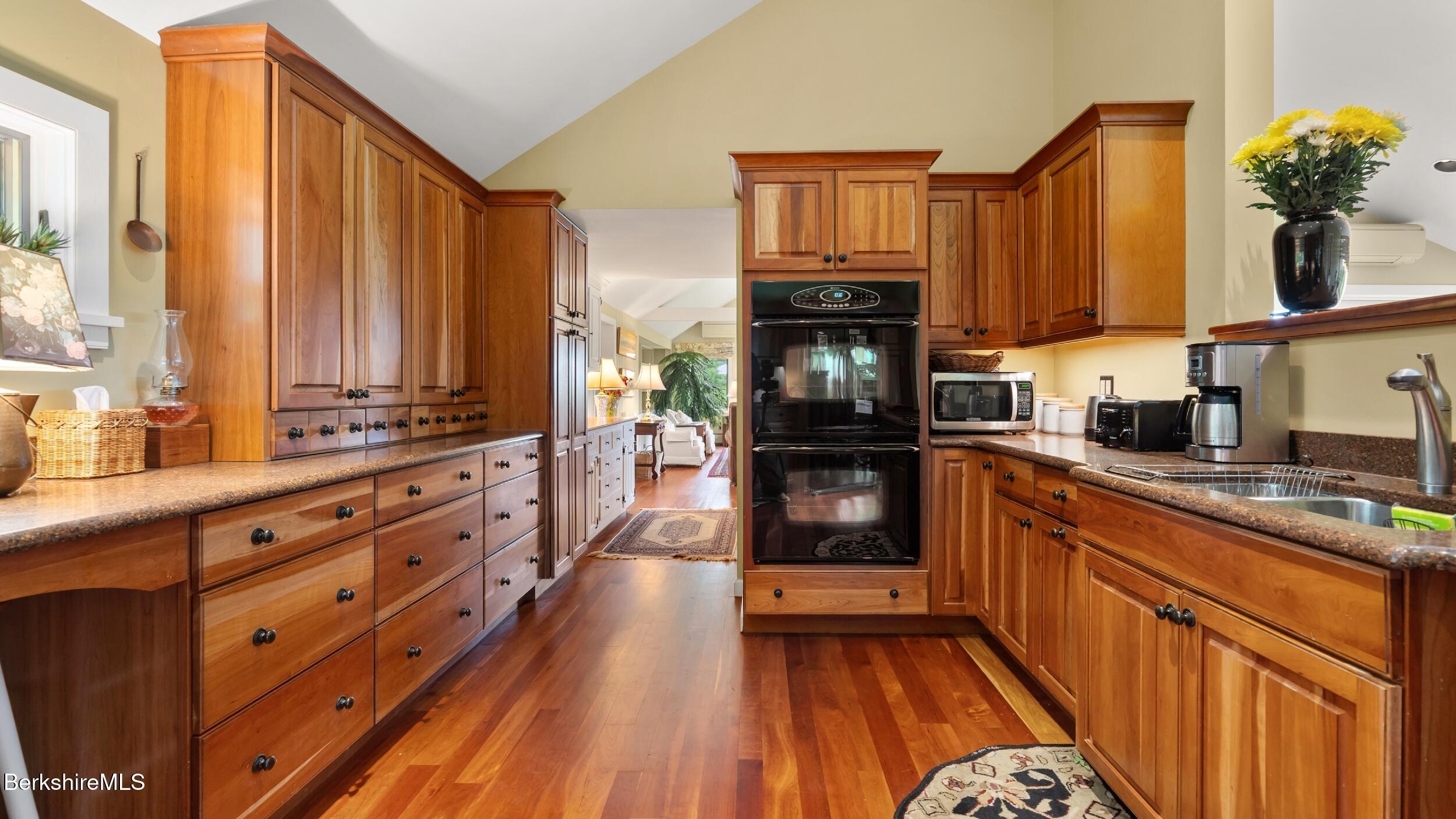 24 Baldwin Hill Road East Egremont, MA 01230 - Photo 8 of 47 a kitchen with granite countertop a stove a sink and dishwasher wooden cabinets with wooden floor