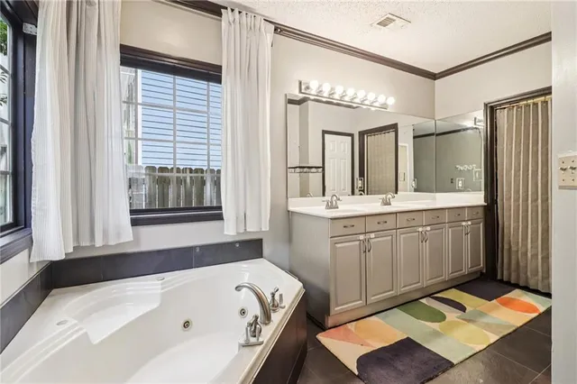 a bathroom with a tub sink and mirror
