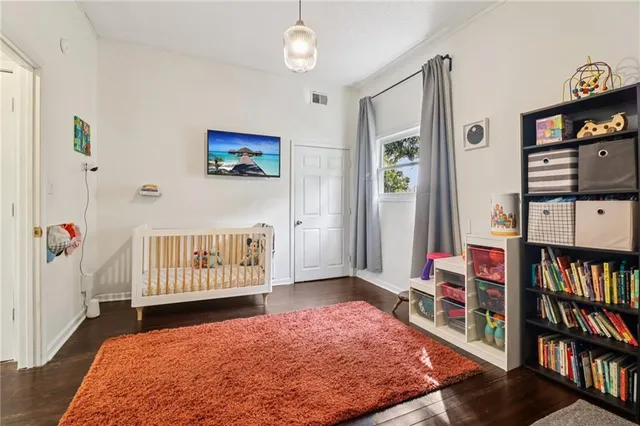 a bedroom with furniture and a book shelf