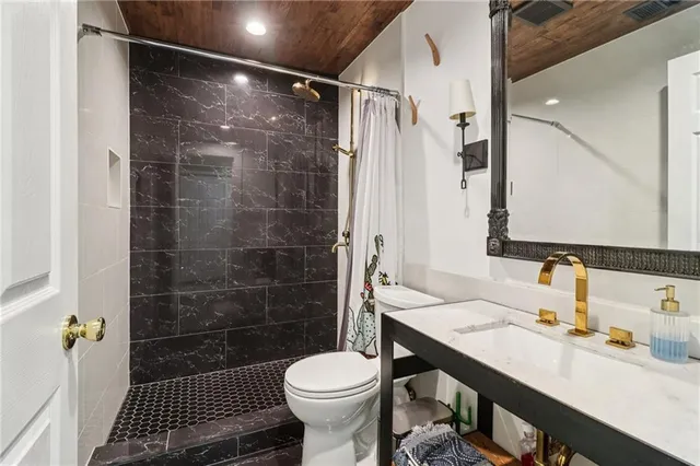 a bathroom with a sink toilet and shower