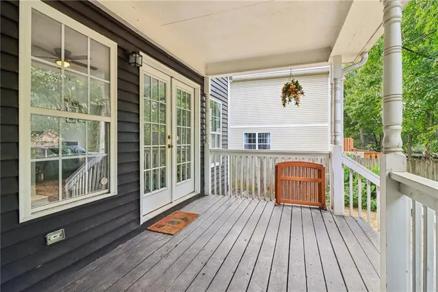 a balcony with furniture and wooden floor