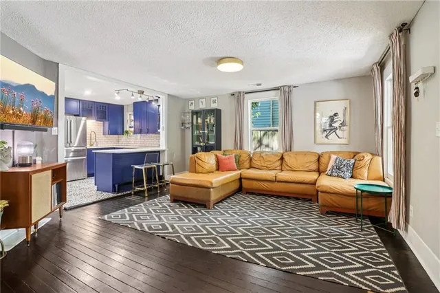 a living room with furniture and a rug