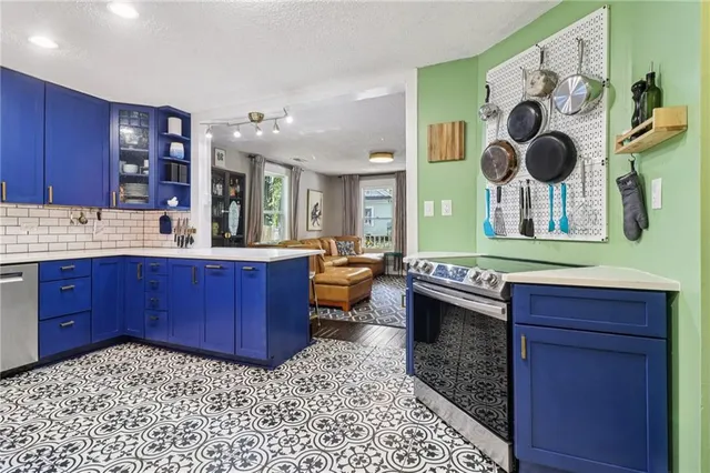 a kitchen with a stove a sink and a wooden cabinets