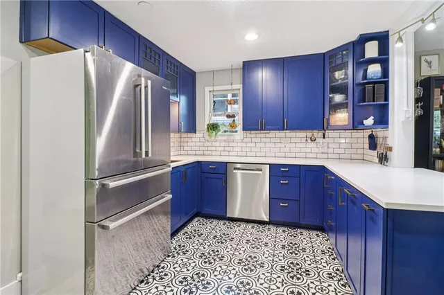 a kitchen with stainless steel appliances granite countertop a refrigerator sink and cabinets
