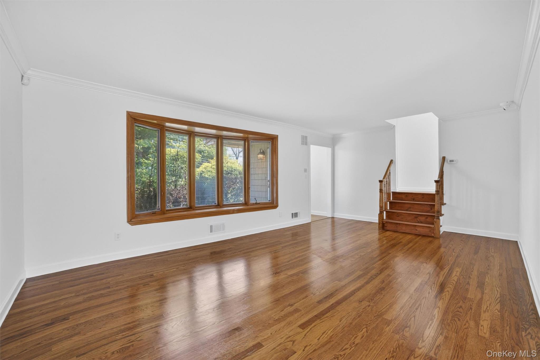 263 Croydon Road Yonkers, NY 10710 - Photo 6 of 43 a view of an empty room with wooden floor and a window