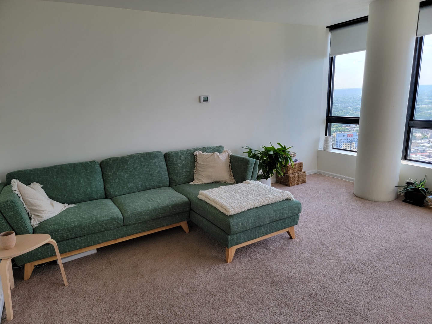 5415 North Sheridan Road, Unit 3807 Chicago, IL 60640 - Photo 5 of 19 a living room with furniture and a potted plant