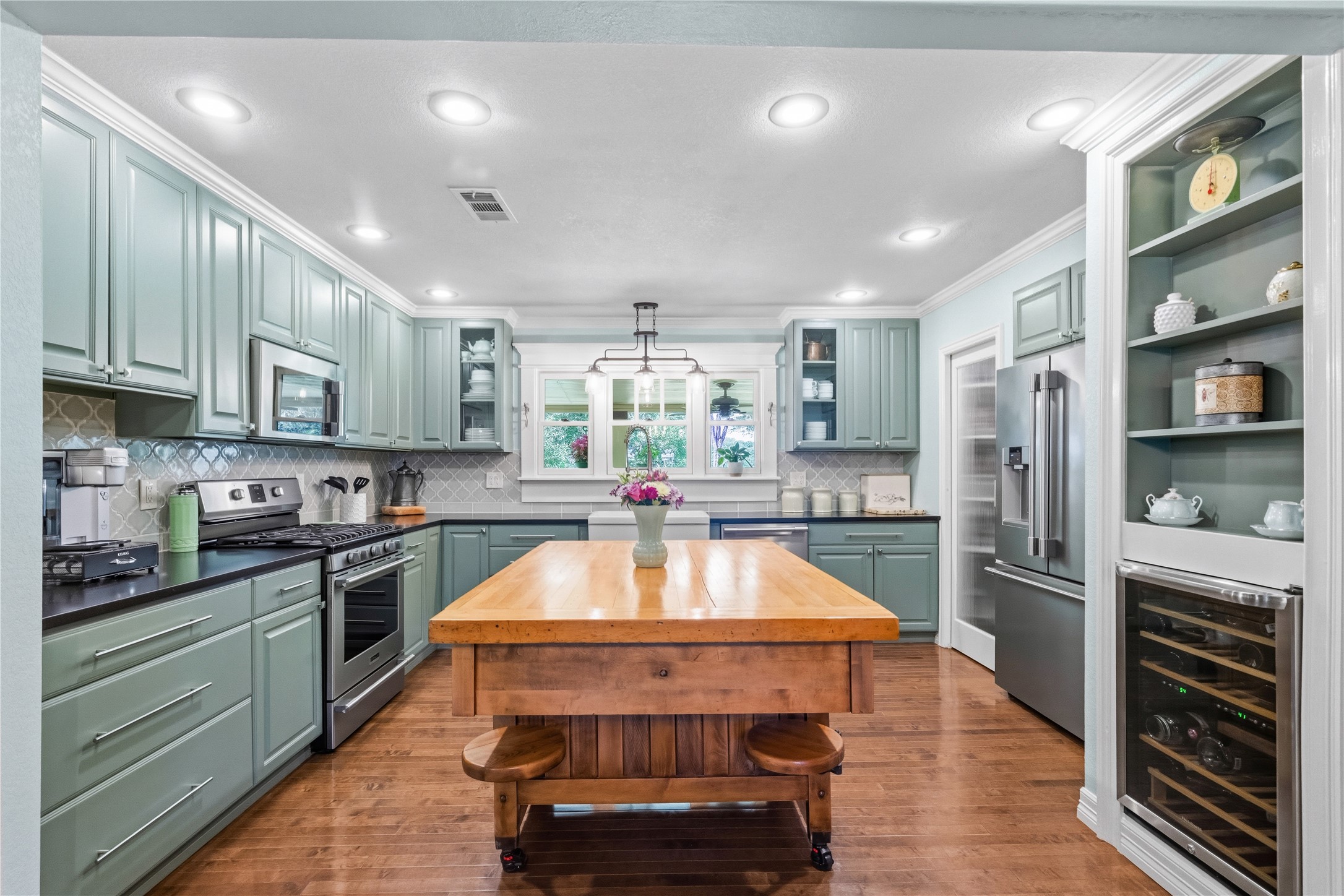 17821 Brown Road Conroe, TX 77306 - Photo 15 of 50 a kitchen with stainless steel appliances granite countertop a refrigerator a sink dishwasher a stove and white cabinets with wooden floor