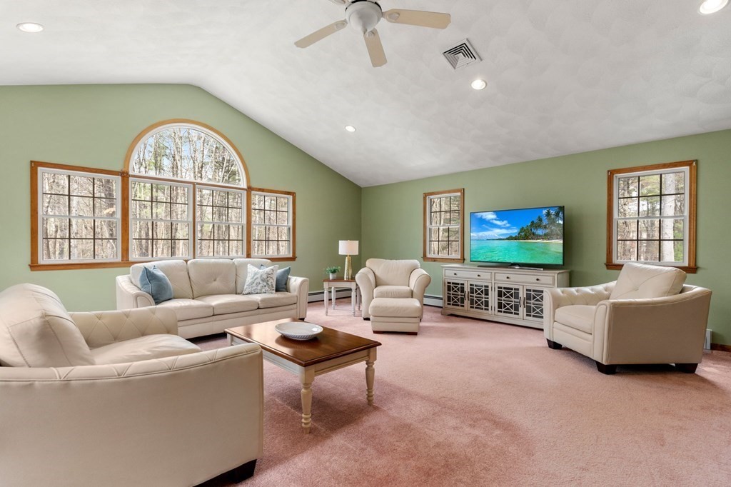 628 Boston Road Groton, MA 01450 - Photo 8 of 32 a living room with furniture a large window and a flat screen tv