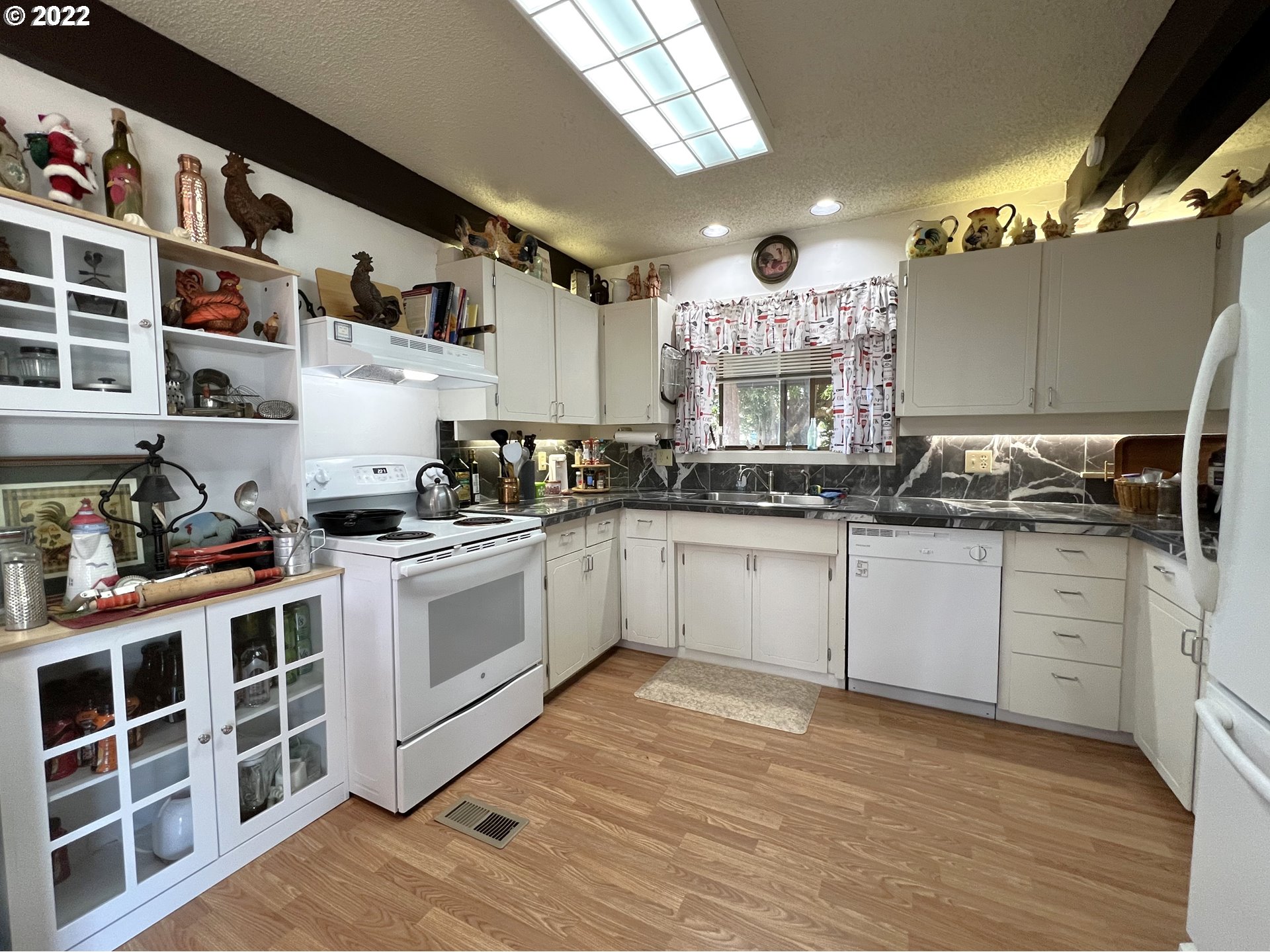 2690 Everett Avenue North Bend, OR 97459 - Photo 11 of 32 a kitchen with stainless steel appliances granite countertop a stove a sink and a refrigerator