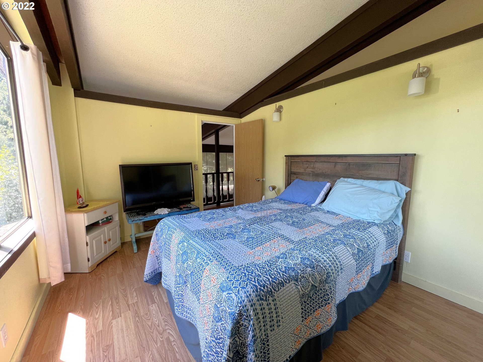 2690 Everett Avenue North Bend, OR 97459 - Photo 16 of 32 a bedroom with a bed and a flat screen tv