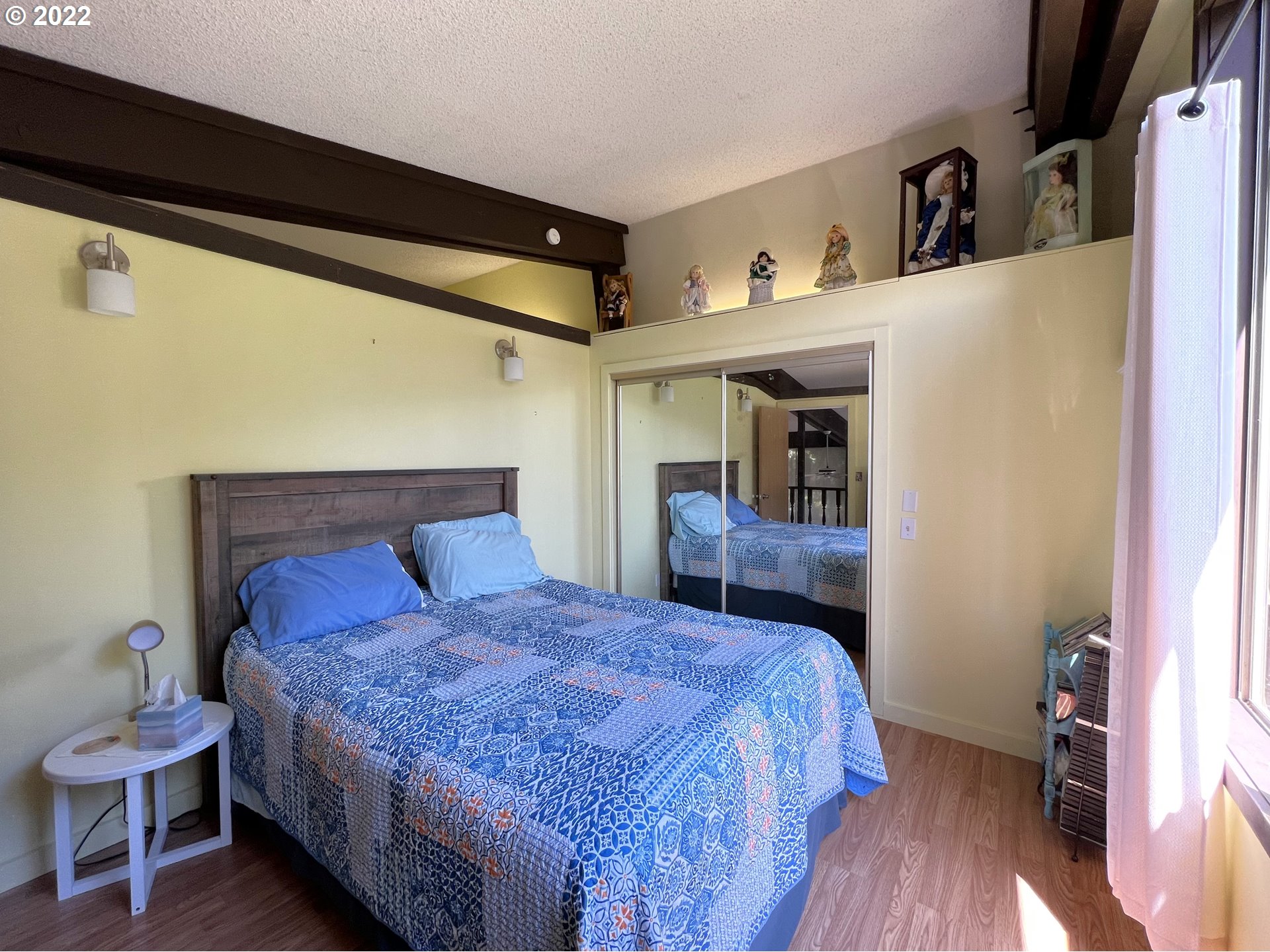 2690 Everett Avenue North Bend, OR 97459 - Photo 17 of 32 a bedroom with a bed and wooden floor