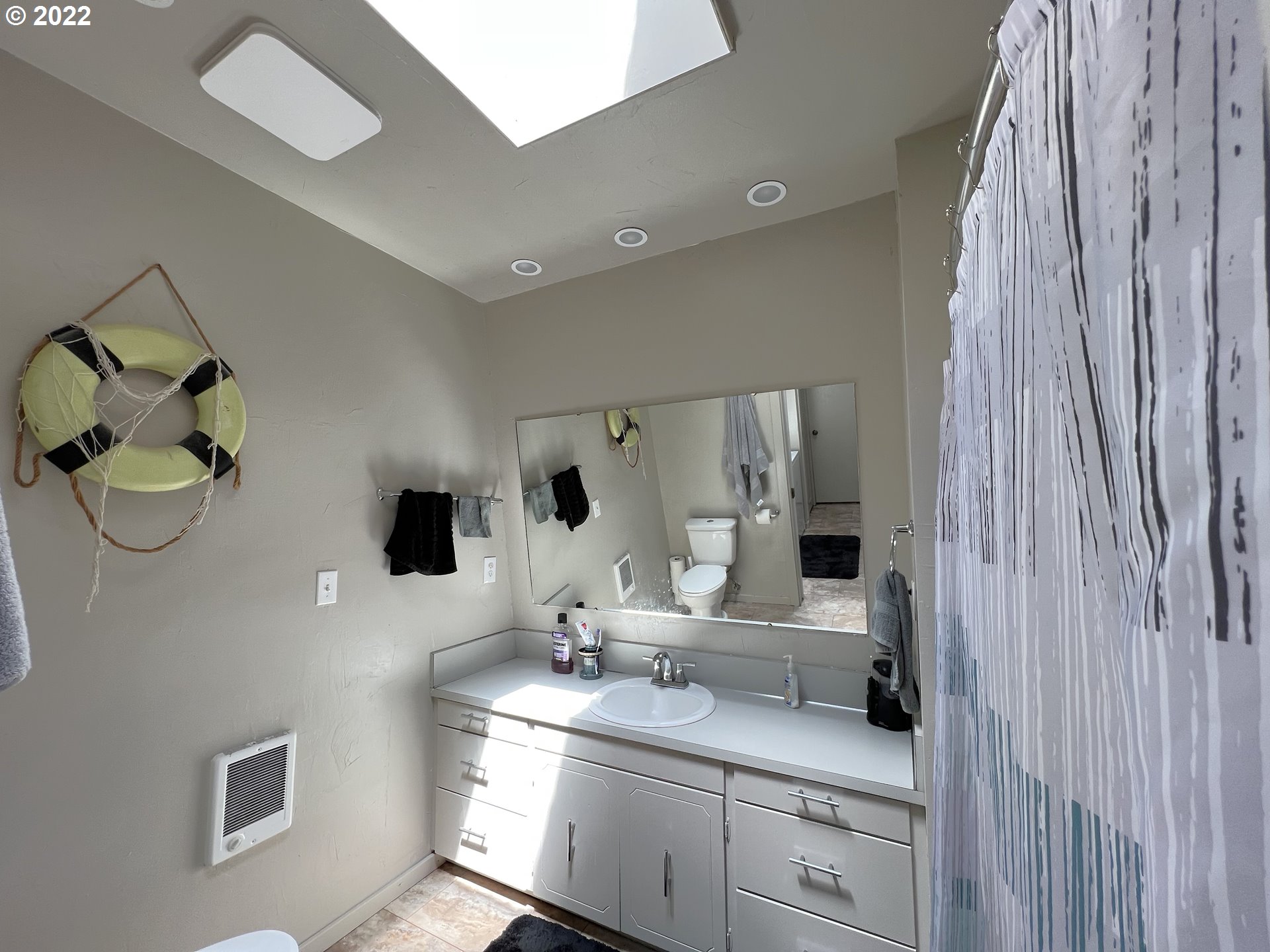 2690 Everett Avenue North Bend, OR 97459 - Photo 18 of 32 a bathroom with a double vanity sink and mirror
