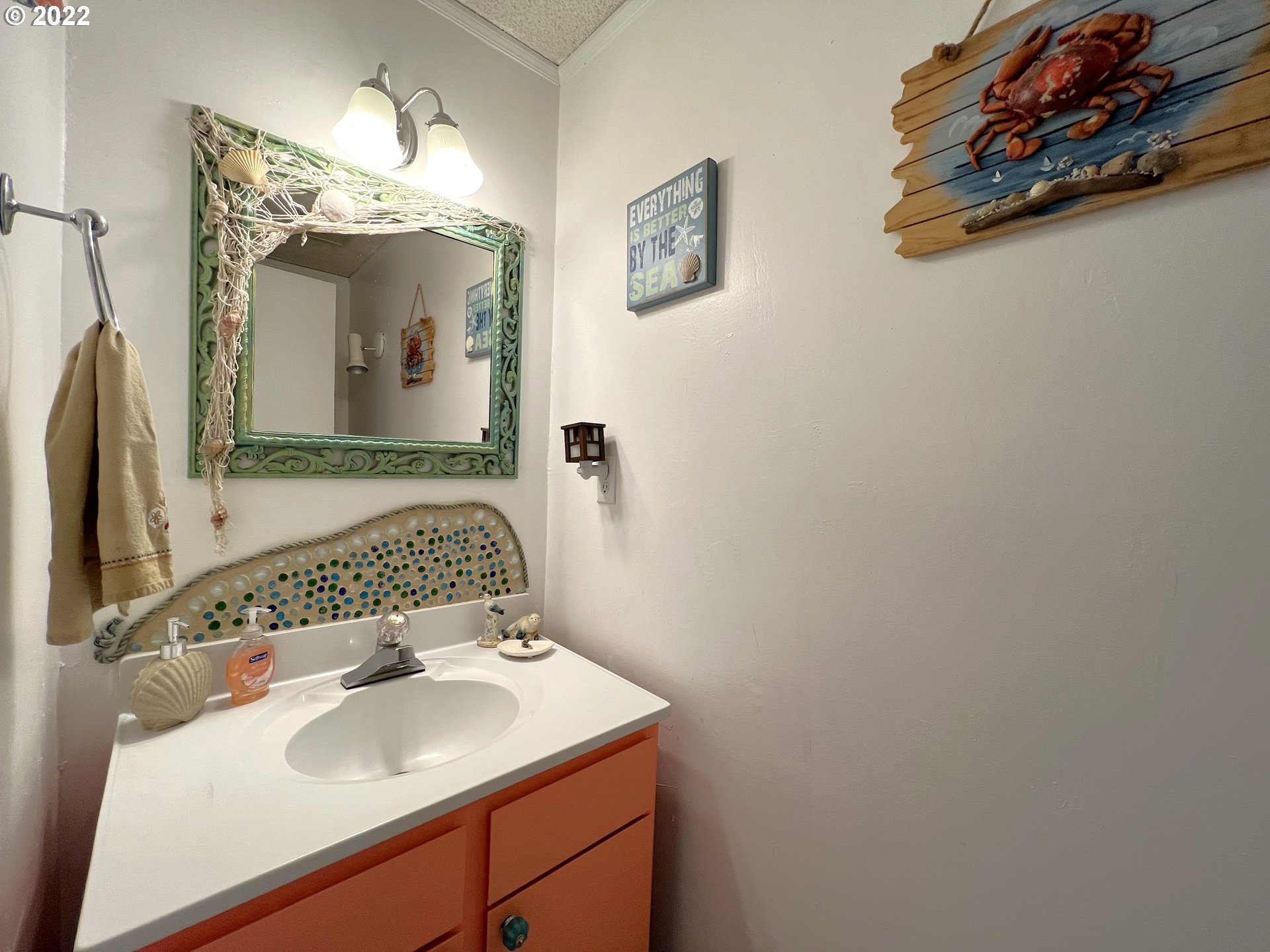 2690 Everett Avenue North Bend, OR 97459 - Photo 19 of 32 a bathroom with a sink and a mirror
