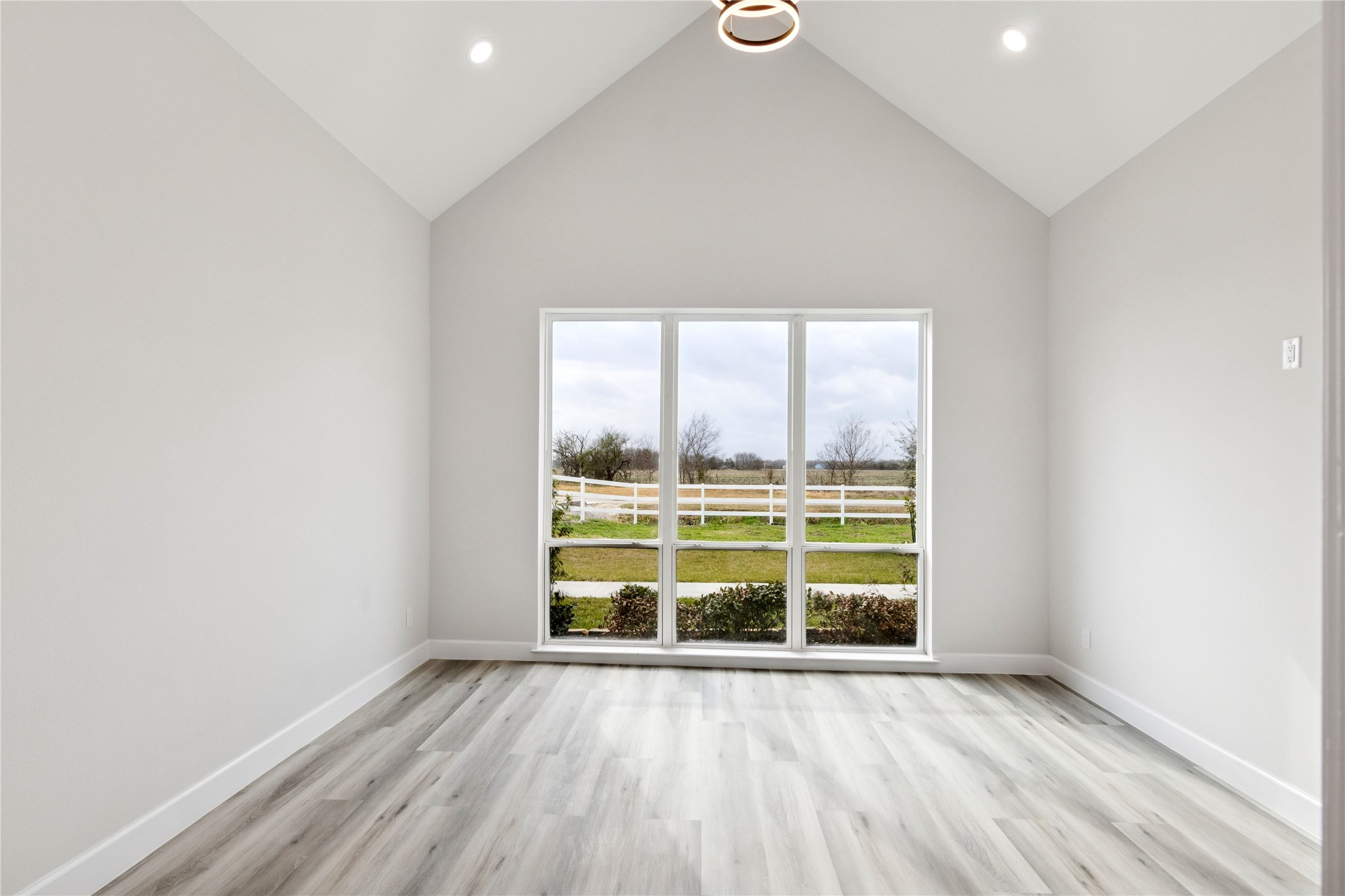 5766 Ward Bend Road Sealy, TX 77474 - Photo 27 of 45 an empty room with wooden floor and windows