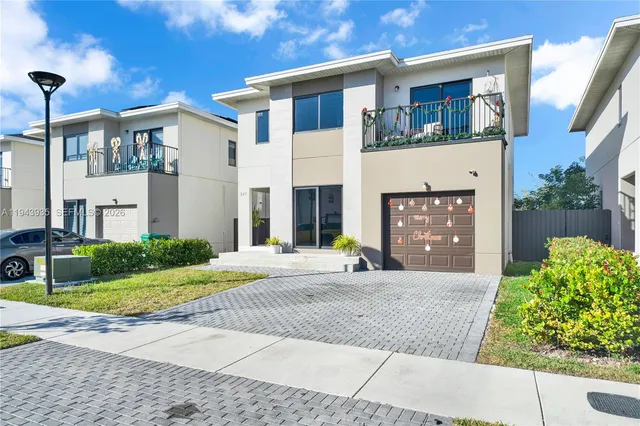 a front view of a house with a yard and a garage