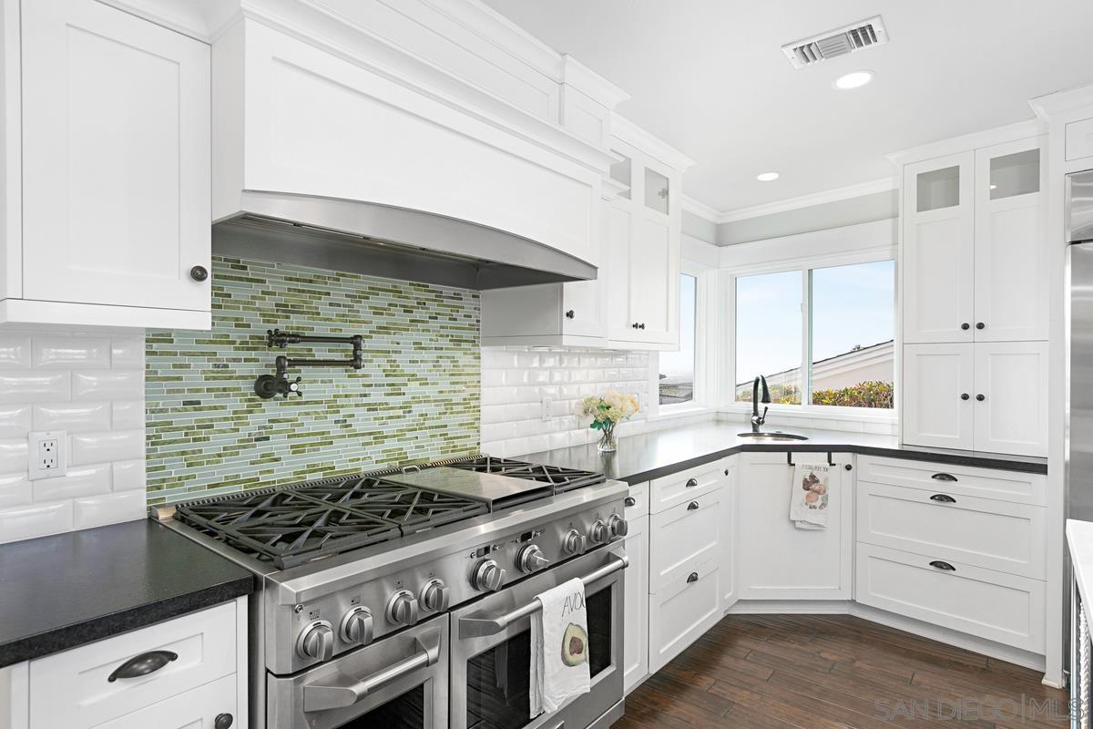 5524 Candlelight Drive La Jolla, CA 92037 - Photo 12 of 27 a white kitchen with sink and stove
