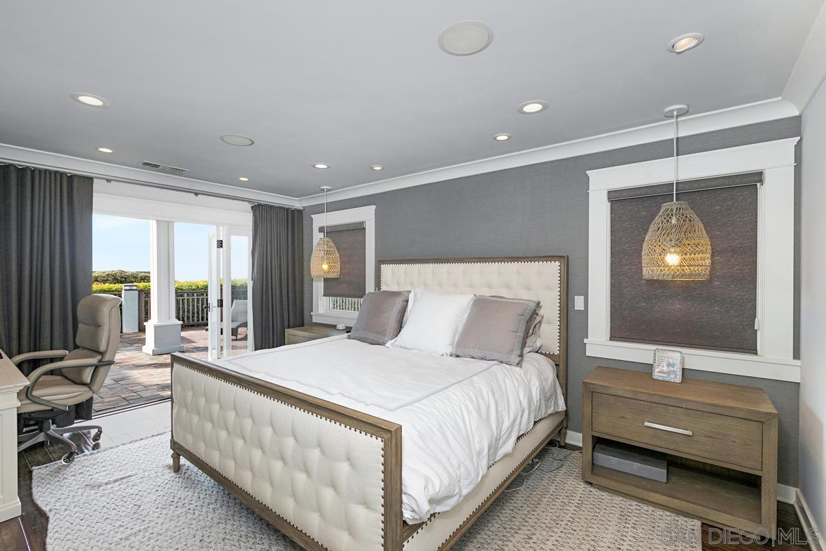 5524 Candlelight Drive La Jolla, CA 92037 - Photo 15 of 27 a large bedroom with a large bed and windows