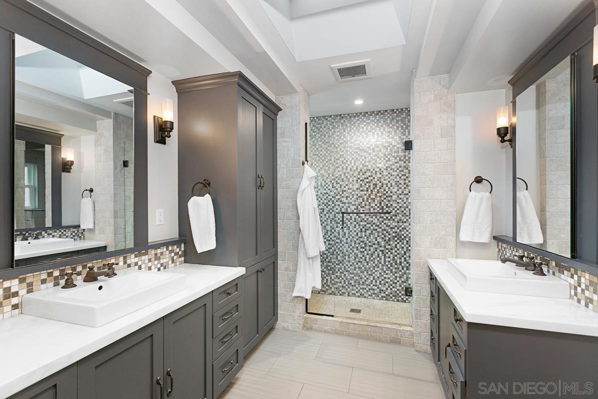 5524 Candlelight Drive La Jolla, CA 92037 - Photo 17 of 27 a bathroom with a sink a toilet and shower