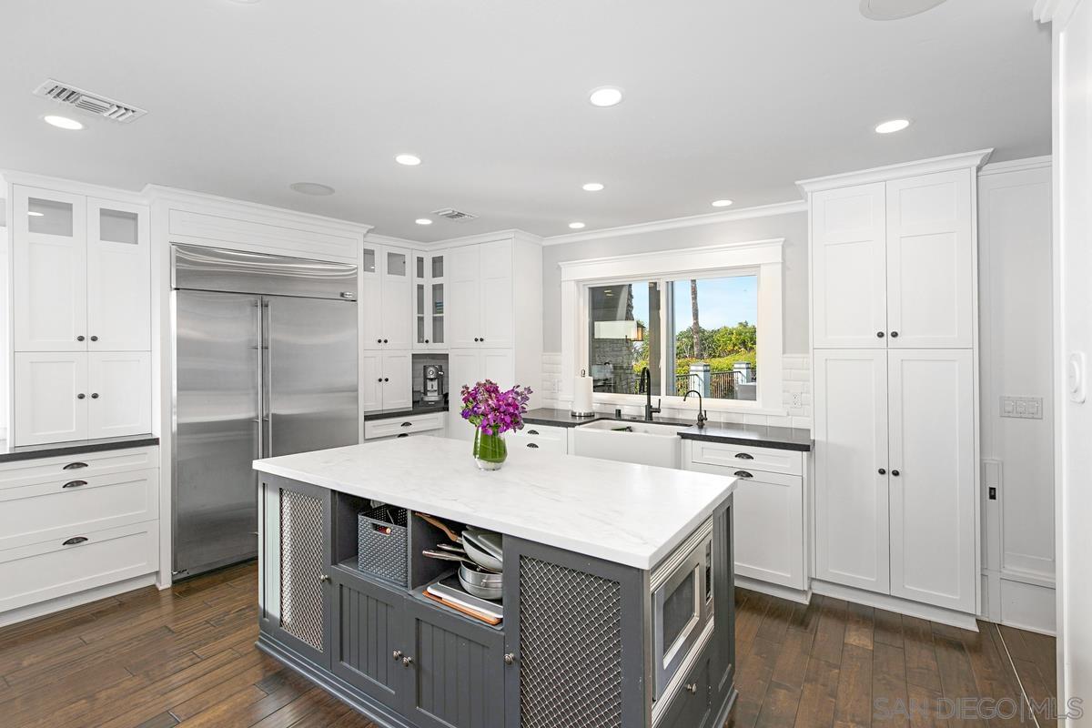 5524 Candlelight Drive La Jolla, CA 92037 - Photo 10 of 27 a kitchen with a sink stove and cabinets
