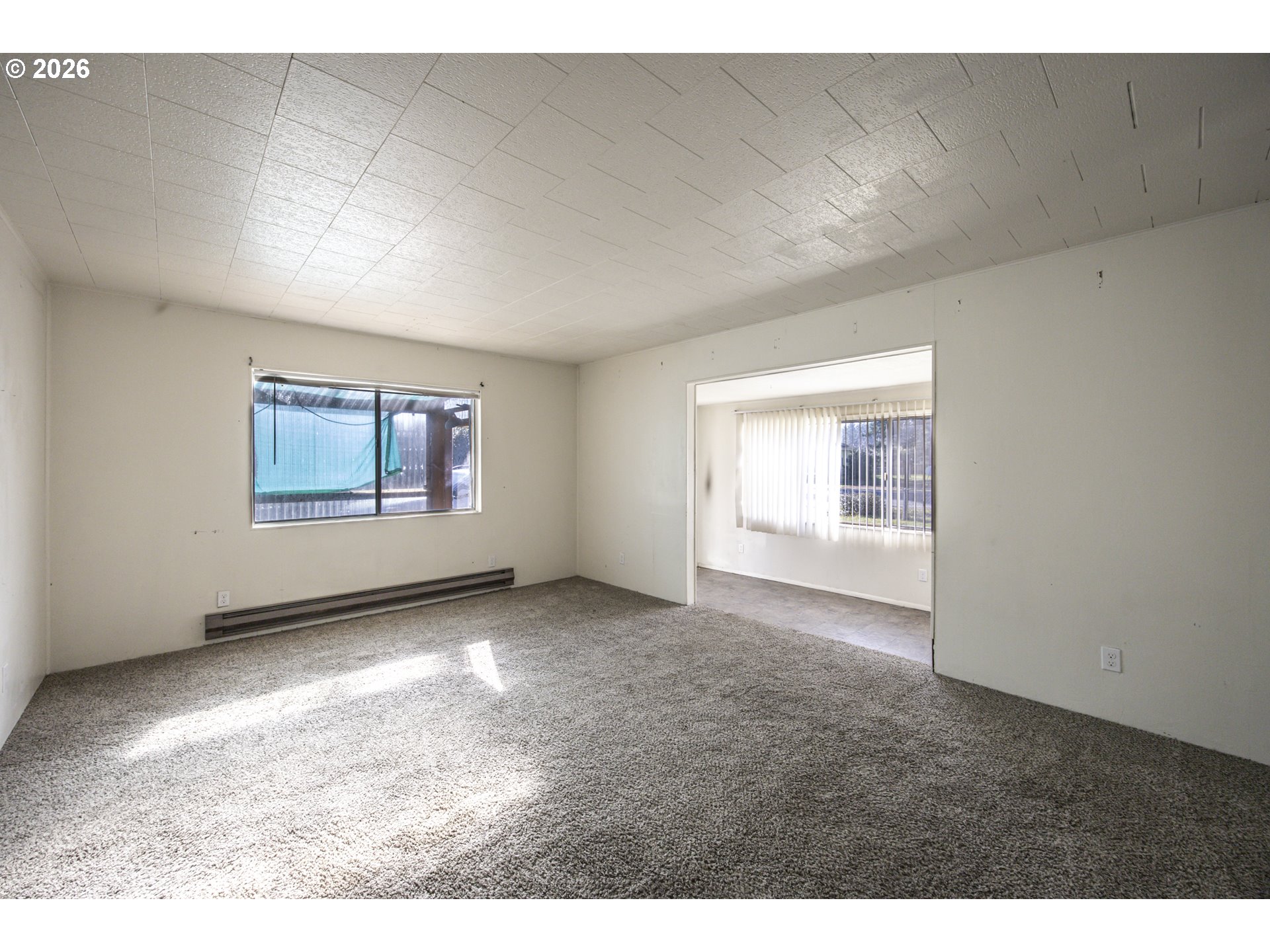 550 North 8th Street Lakeside, OR 97449 - Photo 13 of 31 view of a big room with windows and fireplace