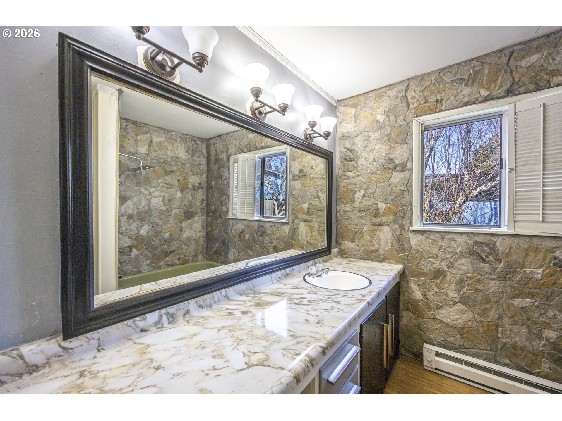 550 North 8th Street Lakeside, OR 97449 - Photo 15 of 31 a bathroom with a sink a vanity and a large mirror