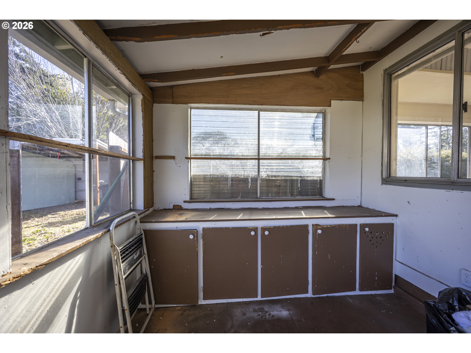 550 North 8th Street Lakeside, OR 97449 - Photo 22 of 31 a kitchen with a sink window and cabinets