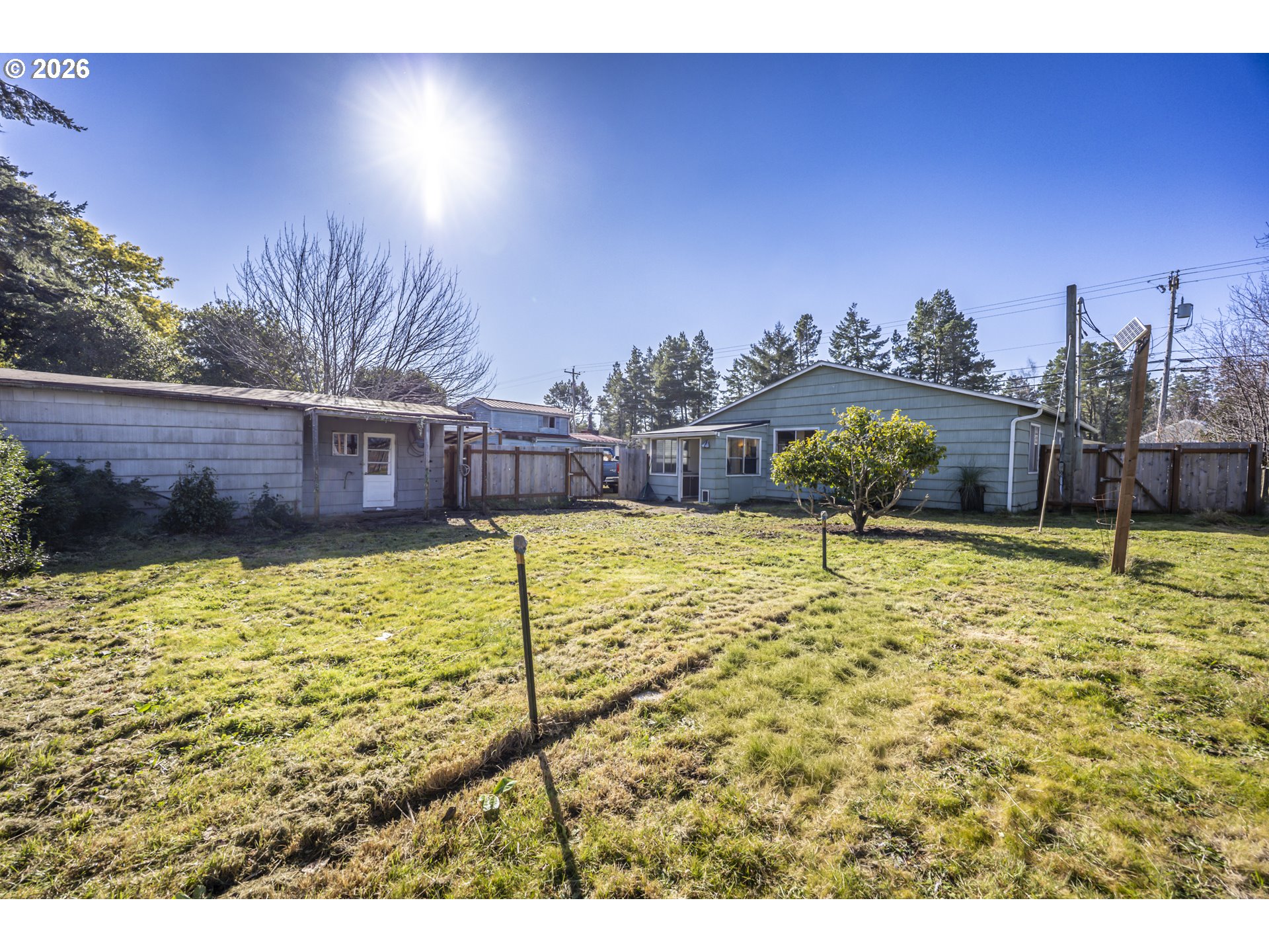 550 North 8th Street Lakeside, OR 97449 - Photo 23 of 31 a view of a swimming pool with a lawn chairs under an umbrella
