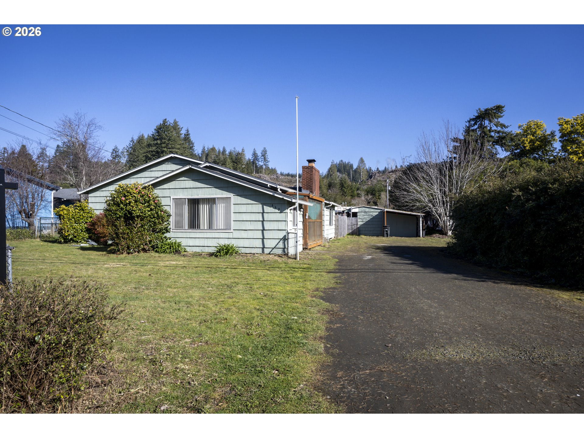 550 North 8th Street Lakeside, OR 97449 - Photo 3 of 31 a view of a house with a yard