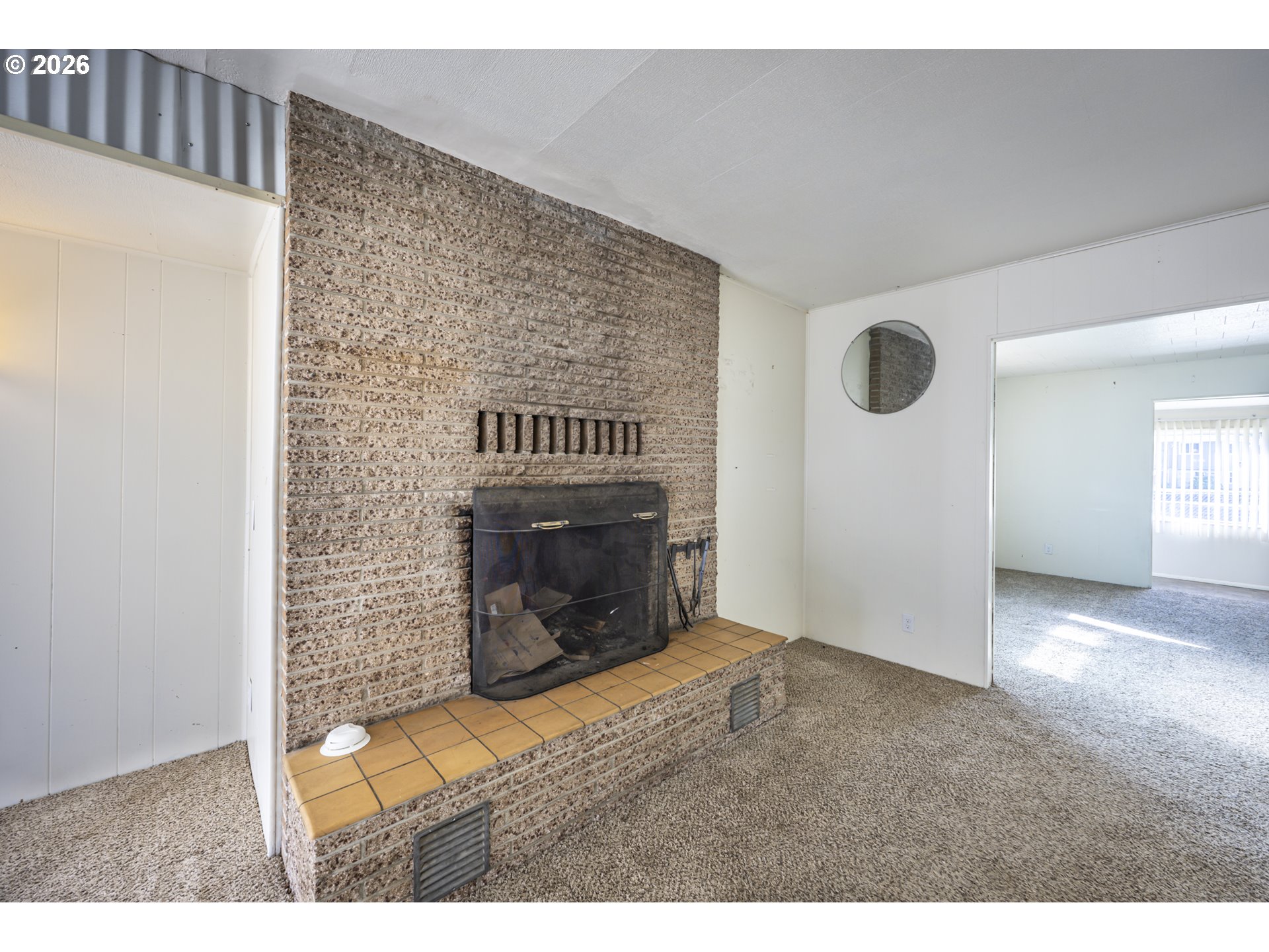 550 North 8th Street Lakeside, OR 97449 - Photo 4 of 31 a view of an empty room with a fireplace