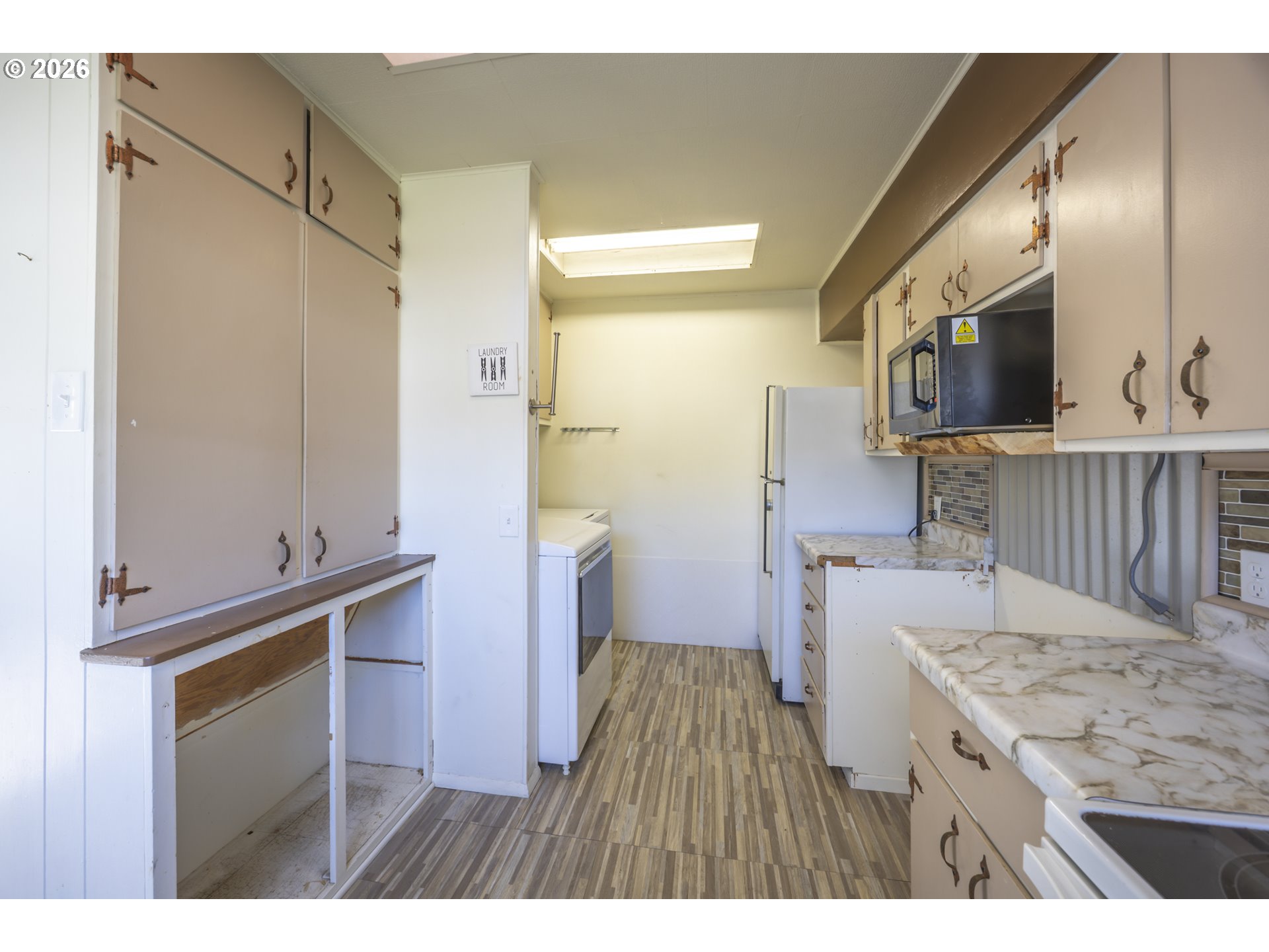 550 North 8th Street Lakeside, OR 97449 - Photo 10 of 31 a kitchen with a sink stove and refrigerator