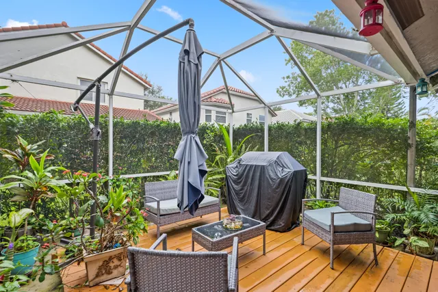 a view of a patio with a table chairs and a backyard