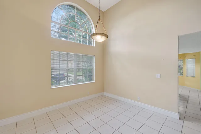 an empty room with windows and entrance