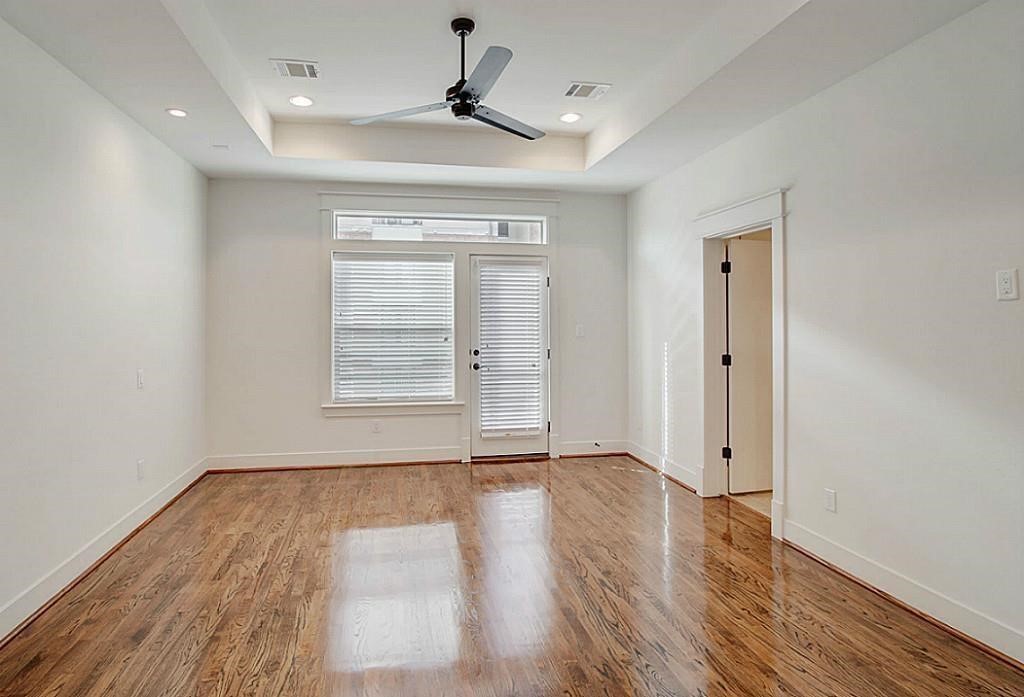 5810 Venice Street Houston, TX 77007 - Photo 15 of 31 a view of an empty room with wooden floor and a window