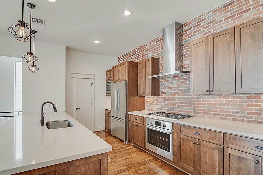 5810 Venice Street Houston, TX 77007 - Photo 7 of 31 a kitchen that has a sink stainless steel appliances and cabinets