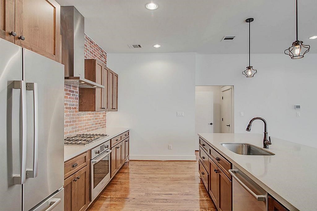 5810 Venice Street Houston, TX 77007 - Photo 8 of 31 a kitchen with stainless steel appliances a sink and a refrigerator