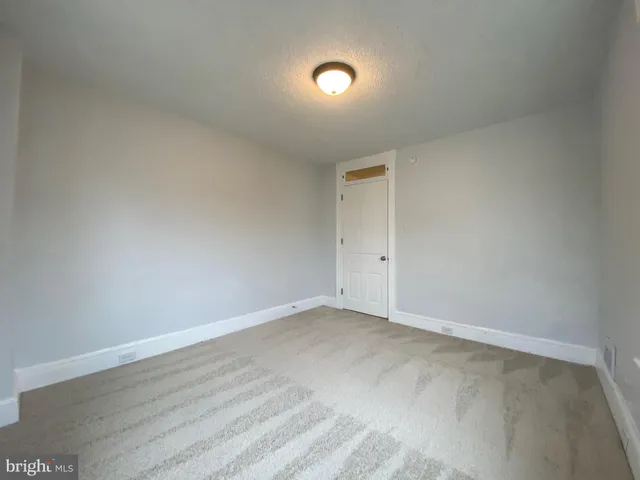 a view of an empty room with windows