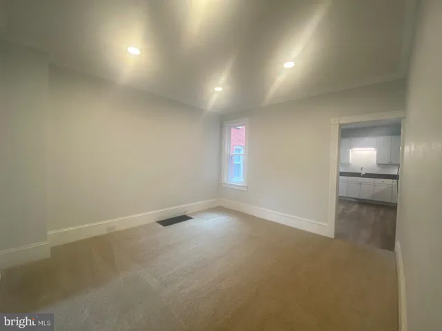 a white toilet sitting next to a bathroom sink and vanity